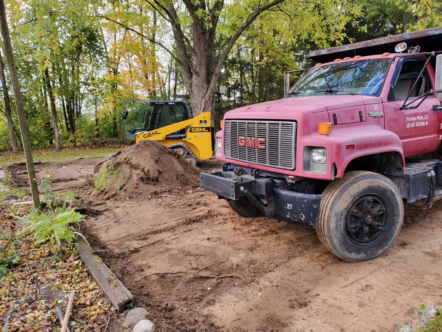 Dump Truck Service - Dump Truck at work site preparing to unload a load of gravel.